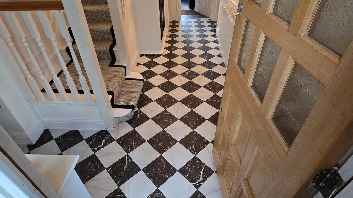 Diagonal checkerboard marble-effect hallway floor with a calm, continuous finish.
