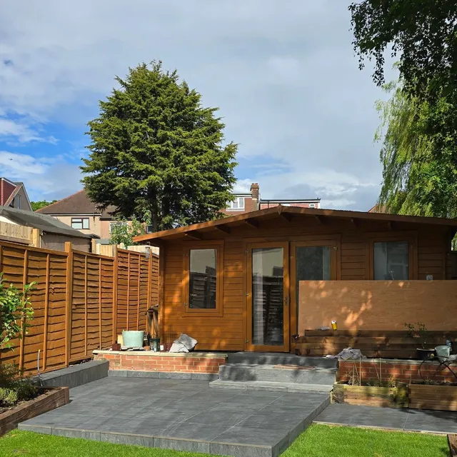 Exterior paving of large-format porcelain slabs in a garden setting.