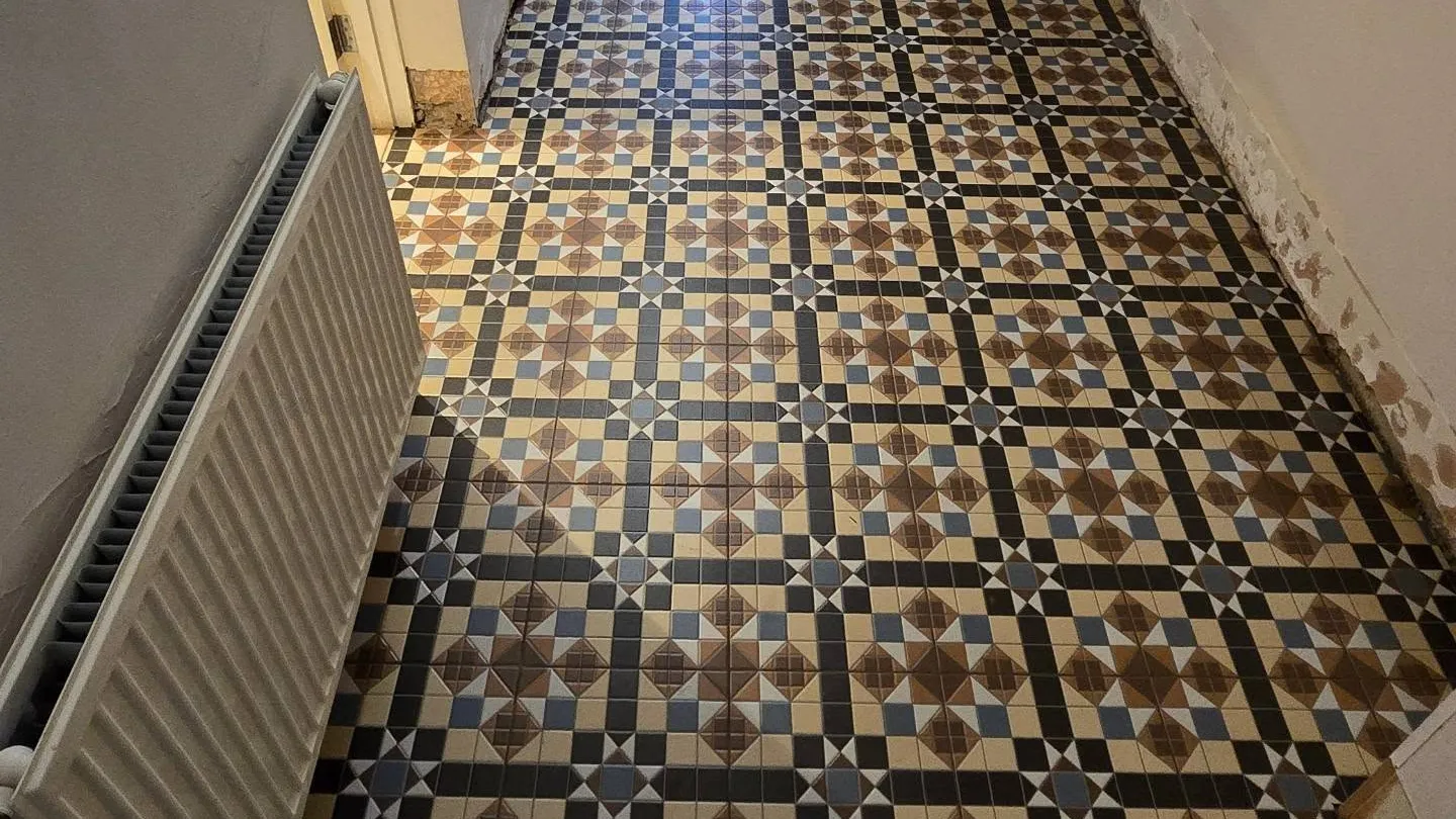 Victorian-style geometric tiled hallway floor in contrasting colours.